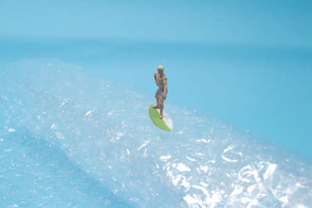 Young surfers figure on the sea, the waves before riding it.の写真素材