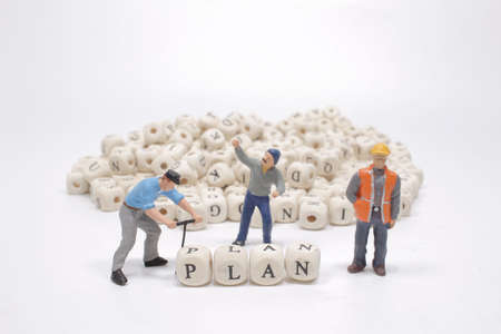 The word plan on wooden cube block with figureの写真素材