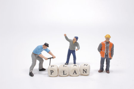 The word plan on wooden cube block with figureの写真素材