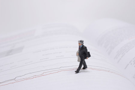 a mini people figure walking on open pages