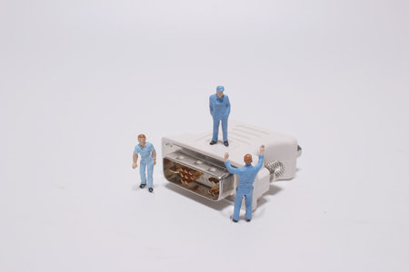 a mini construction worker figurines posed as if working on cable