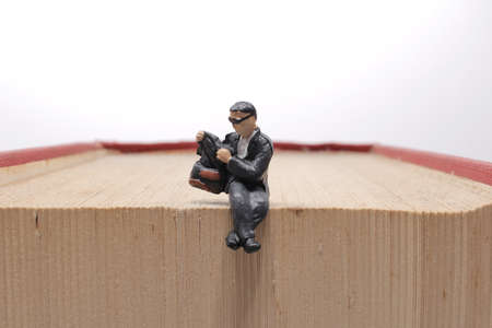 mini people reading with book, education or business concept.