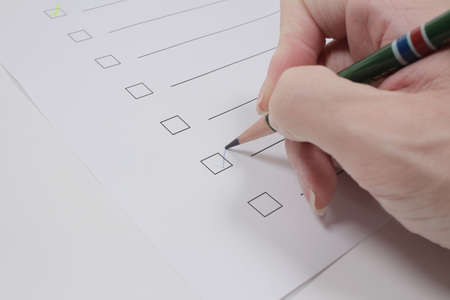 the Checkbox, Checklist with pencil and handの写真素材