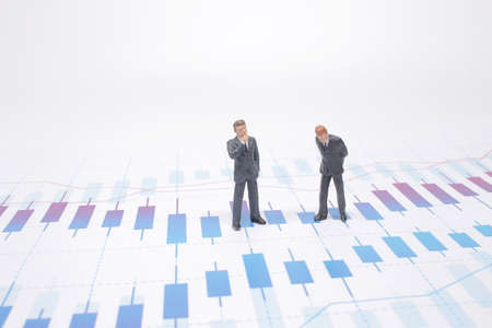 Businessmen are skeptical looking at stock market charts.の写真素材