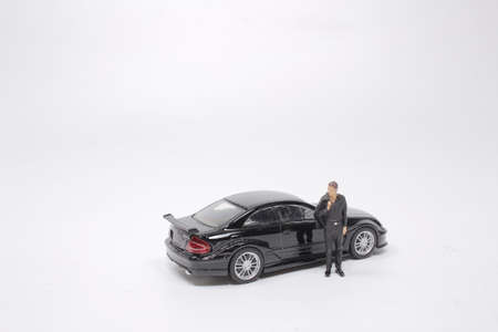 the mini businessman figurine and miniature sports car