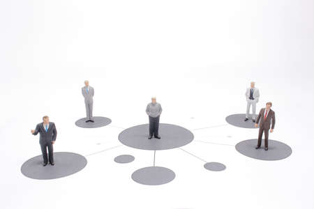 close up of miniature people with social network diagram on openの写真素材