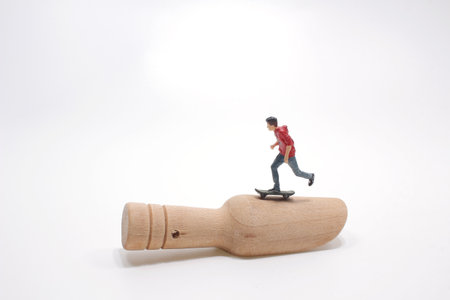 the mini figure play the Skateboard on wood spoonの写真素材