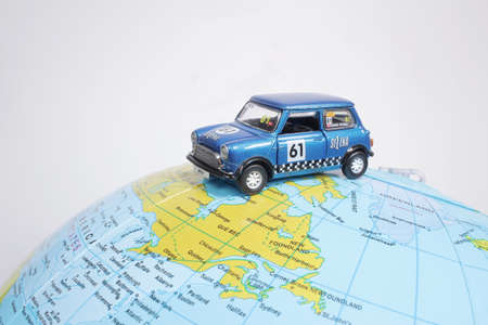 figure toy car on geographical globe of earthのeditorial素材