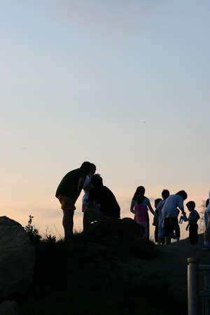 2 July 2005 A group of people stands on a hill over the sunset