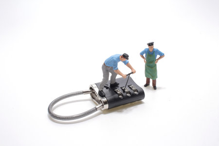 A little man is trying to break the password lock.の写真素材