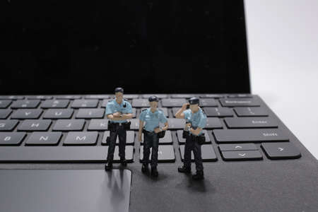 a Police Squad Protecting Computer keyboard. Technology Conceptの写真素材