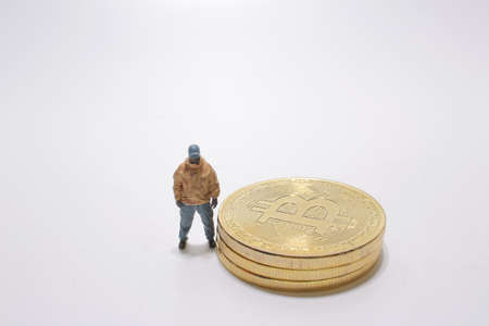 the mini figure with the bitcoin on boardの写真素材