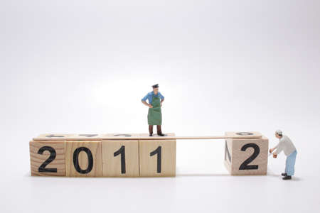 mini worker moving wooden cube to 2012の写真素材