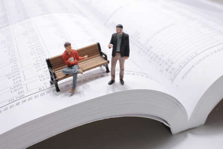 mini figure with coffee and discuss business plan.の写真素材