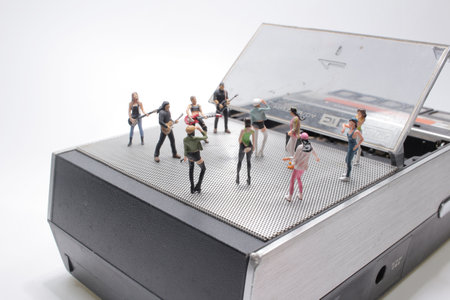Miniature Singer And Guitar Player Standing On speaker