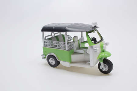 a scale of Thailand three wheel native taxi at board