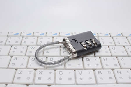 Metal code padlock on laptop keyboard, space for text
