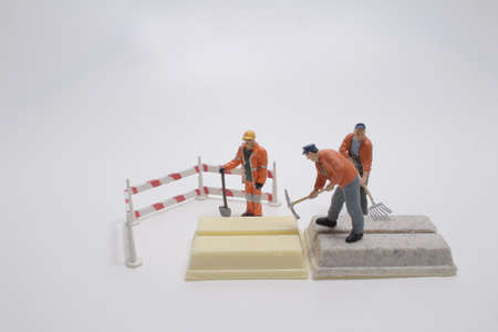 A tiny worker model is working on chocolateの写真素材