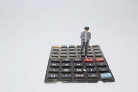 Business and technology concept. businessman miniature figures standing keyboard