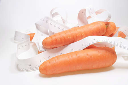 the measuring tape with the Carrot on the white boardの写真素材