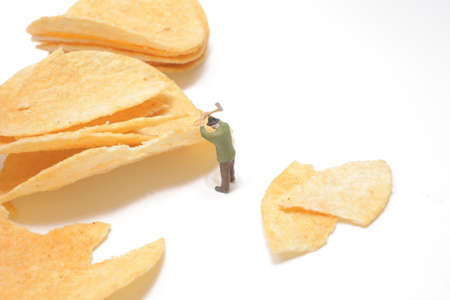 Strong man splitting logs of the potato chips