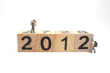 a mini travel figure on wooden cube to 2012
