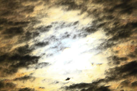 the Sun shining through dark clouds at winter