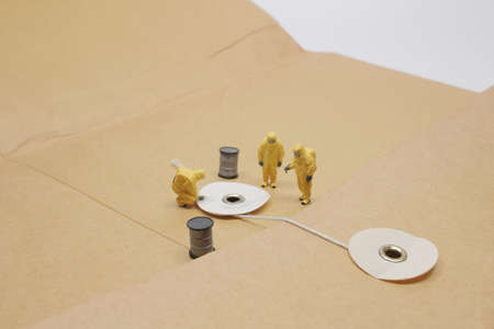 The mini of worker figure is cracking the briefcaseの写真素材