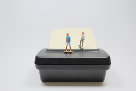 the mini figure play the Skateboard on memo padの写真素材