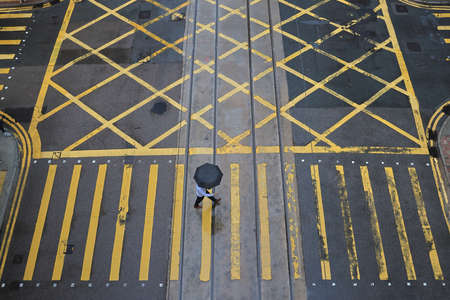 people crossing a very busy crossroads at Central, hong kongの写真素材