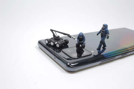 mini Police Swat Team Officers Using a Mechanical Robot Unit on  mobile phone