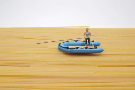 The tiny figure with a small boat and fishingの写真素材