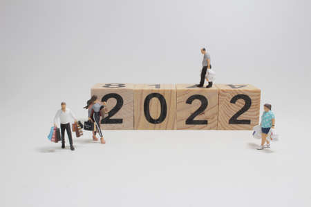 the mini of figure with shopping bags, Year 2022 Word on Wooden Block