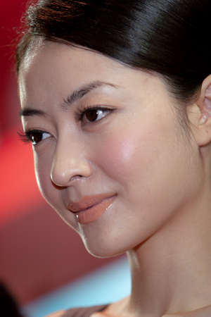 young hostesses stand next to products at the exhibition. 25 Aug 2007のeditorial素材