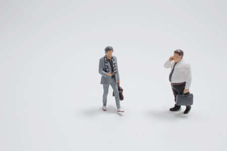 the mini business man use the mobile phoneの写真素材