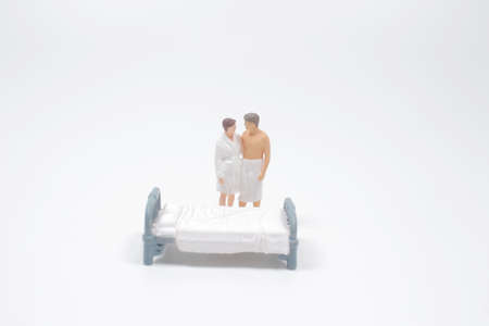 the lover figure stand on the bed behindの写真素材