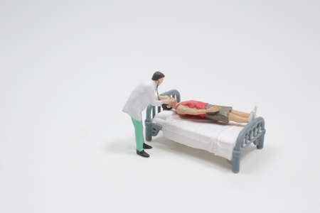 mini doctor uses a tablet to explain the treatment of maleの写真素材