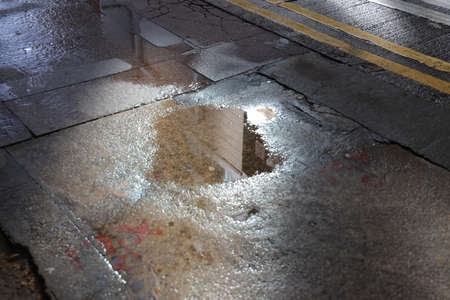 14 Oct 2021 Interesting reflection in the puddle on the ground block pavement.  after the rainの写真素材