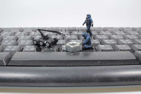 Bomb Disposal Expert in Bomb suit on keyboard