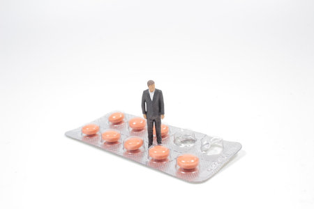 Health Care, the business man stand on pills