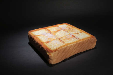 A Single slice of lightly toasted white bread