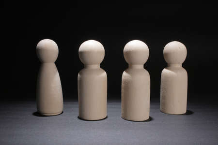 Wood Figurine Teamwork Concept, the dark backgroundの写真素材
