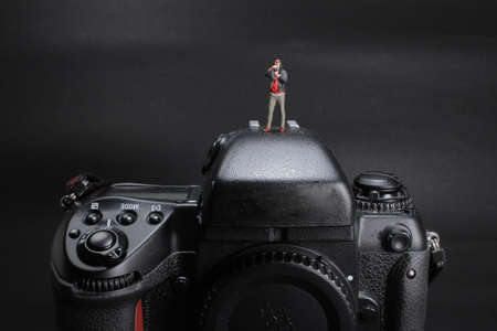 the Miniature photographer standing on a cameraの写真素材