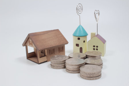 Miniature colorful house on stack coins using as property and financial concept