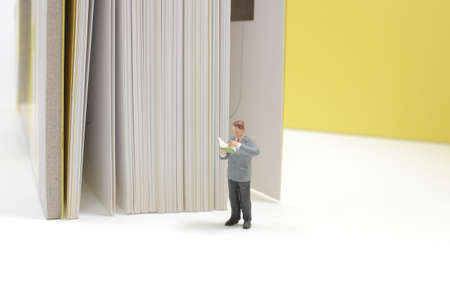 Reading and hobby concept, mini figure with a big book.