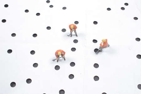 the small figure of a man digging concrete roadの写真素材