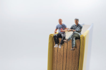 the mini figure sit on the book and drink coffee