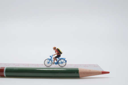 people ride bicycles on wooden ruler.の写真素材