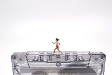 the fun mini figure running on a Music Cassetteの写真素材