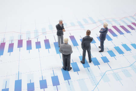 a mini Businessman thinking with project for investmentの写真素材